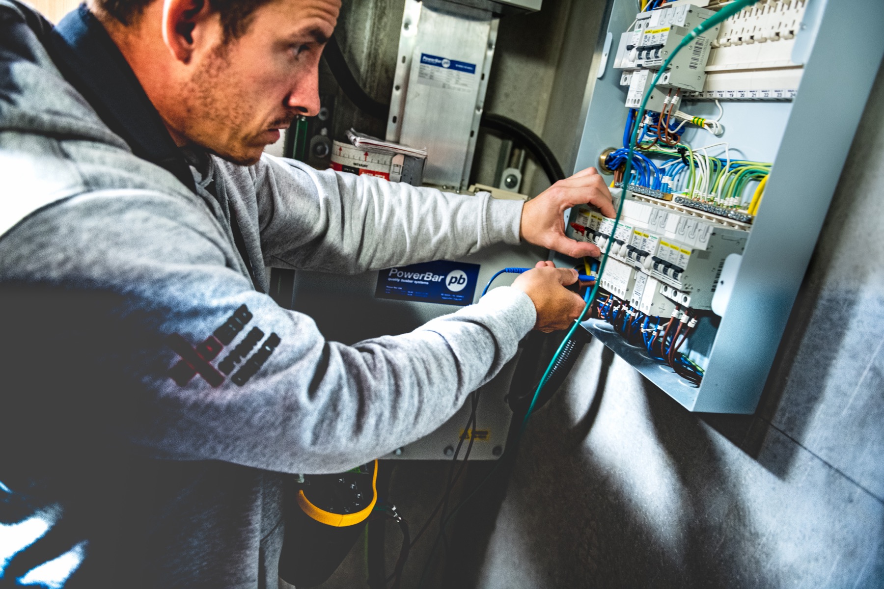 Stator electrician testing a commercial distribution board